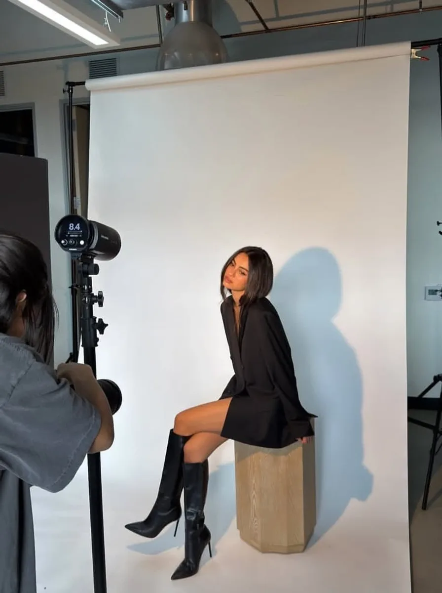 A photographer shooting a founder against a studio backdrop