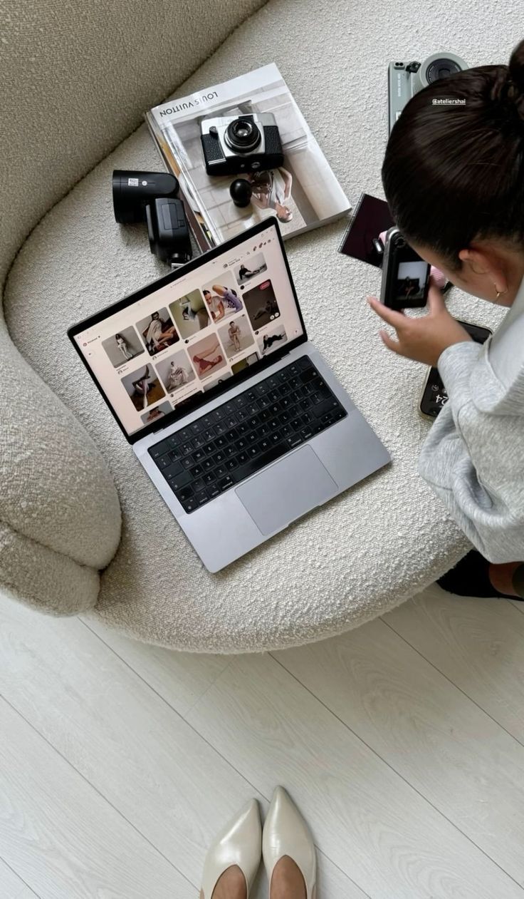 Creative business owner photographing products beside a laptop and camera equipment