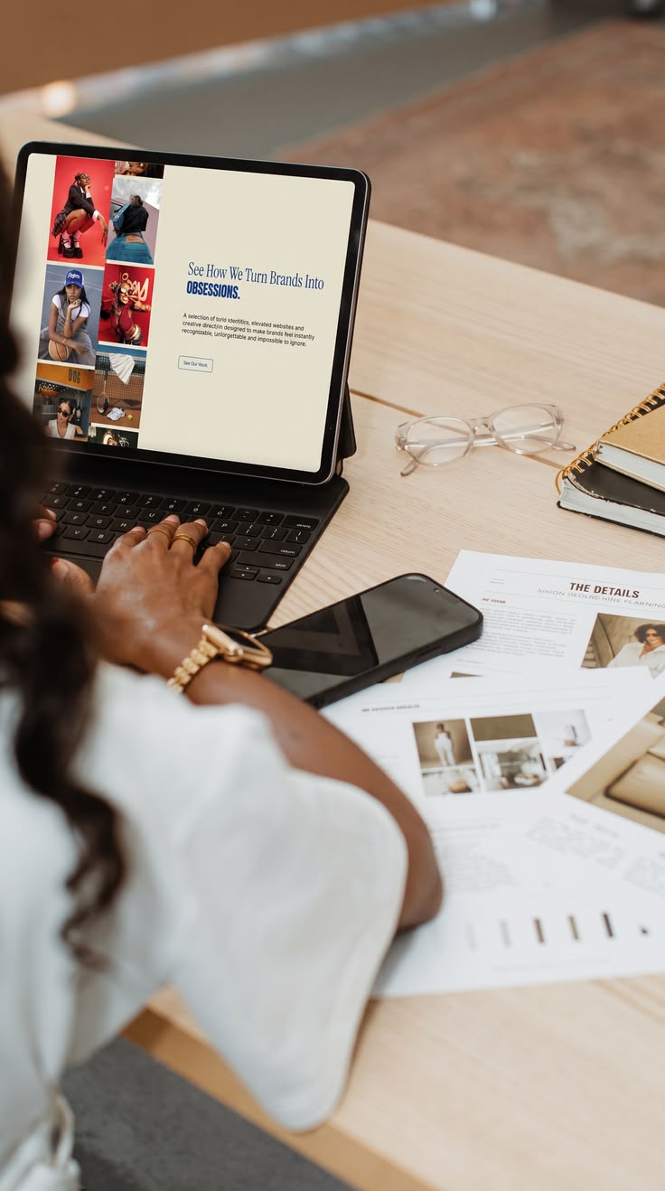 Marketing founder reviewing a website on a tablet beside campaign materials